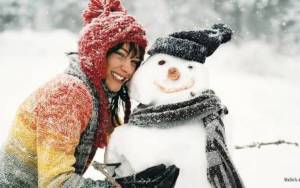 Девушка обнимает снеговика